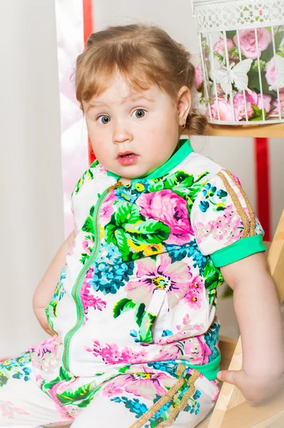 Baby girl in a fashionable suit, cap