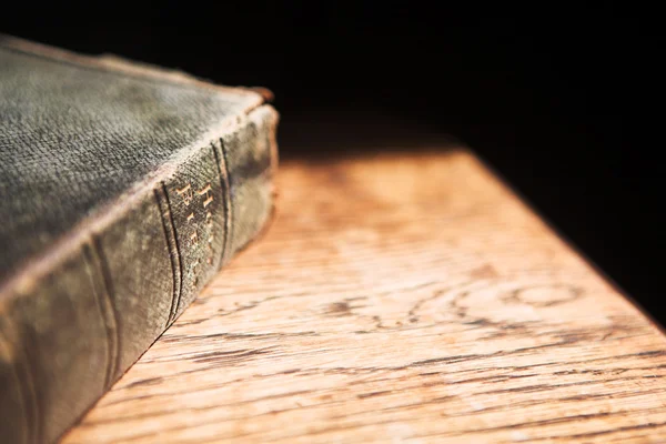 Old bible lying on a wooden table