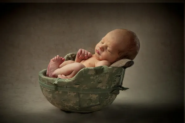 Newborn Baby in Military Helmet