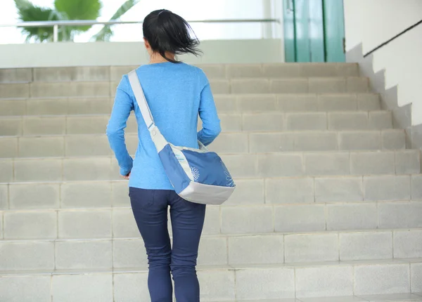 Adult student running at stairs