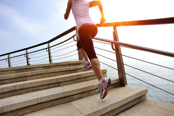 Woman running on stone stairs seaside