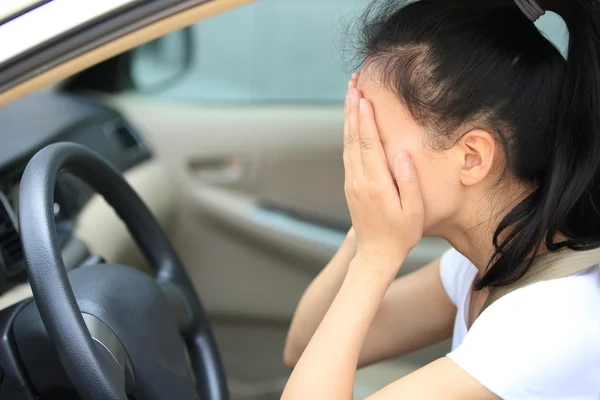 Sad woman driver in car