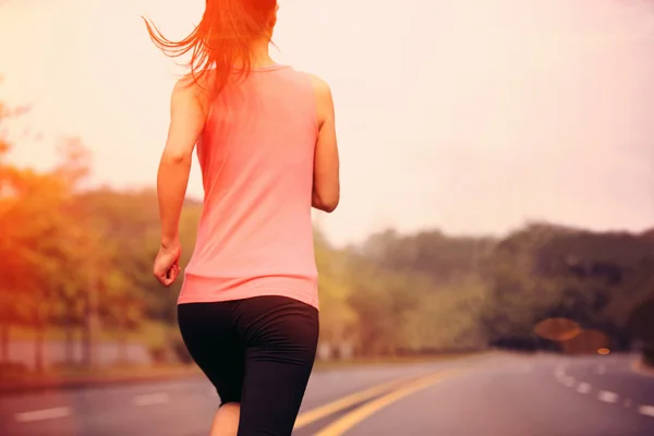 Sporty woman jogging at tropical park