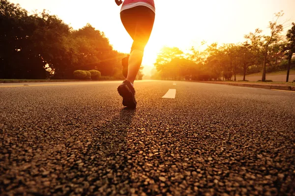 Runner athlete running on tropical park trail