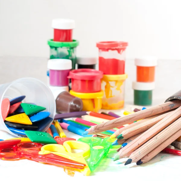 Colored pencils and other tools for drawing on table