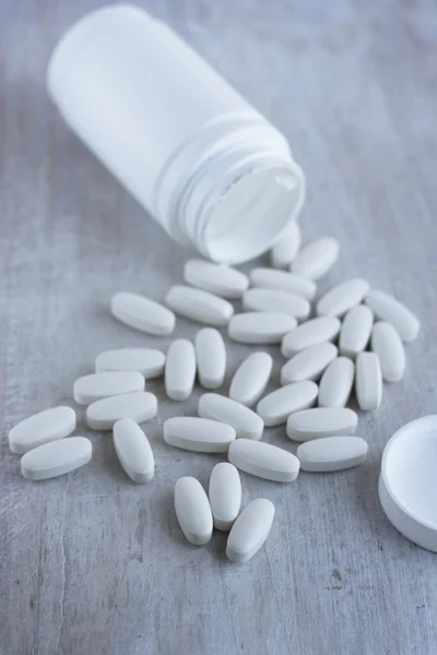 Oblong medicine tablet on the white background