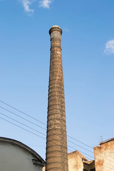 Old factory brick chimney cracked