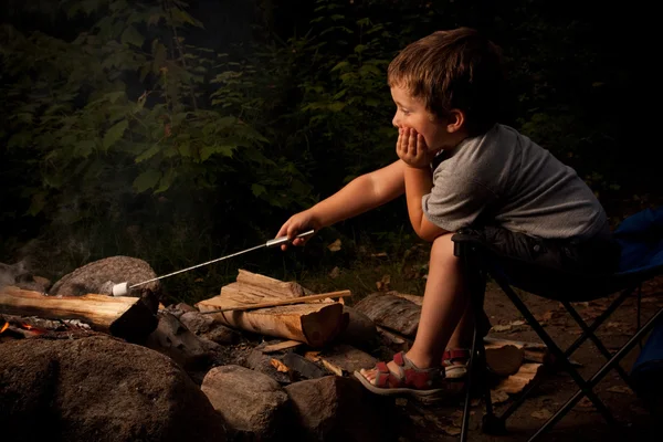 Boy cooking marshmallow