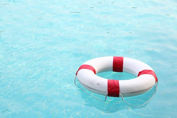 Red and white rescue wheel on swimming pool
