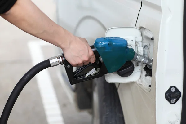 Closeup of a man's hand refilling a car with a petrol,gasoline