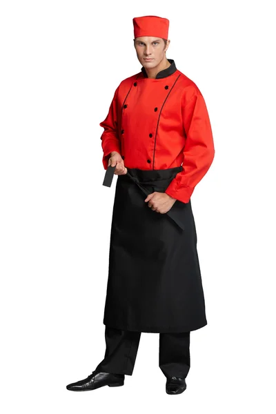 Young man in the form of a waiter or chef, white shirt, blue apron, black pants