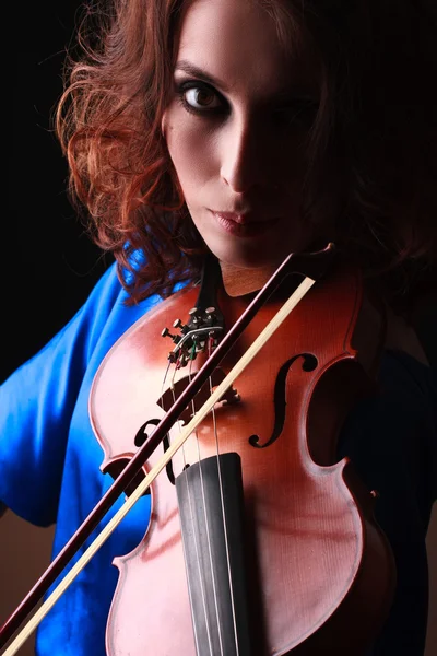 Violin playing violinist musician. Woman classical musical instrument player on black