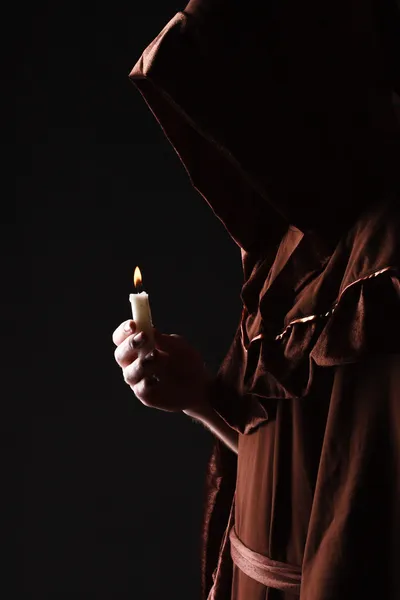 Wizard in black cape with candle