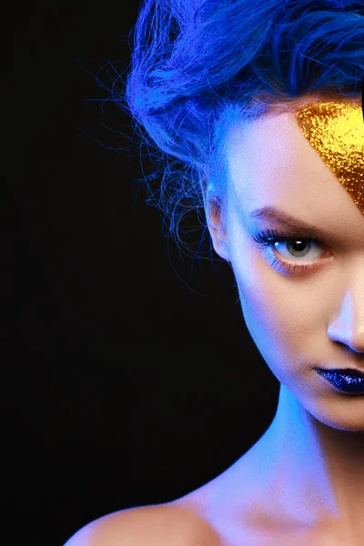Portrait of young woman in superhero cosmetics