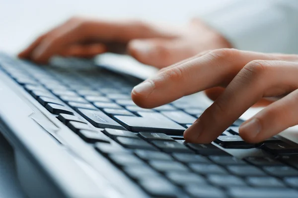 Image of man's hands typing