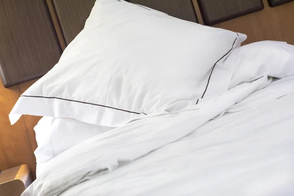 Hotel bed pillow and white sheets