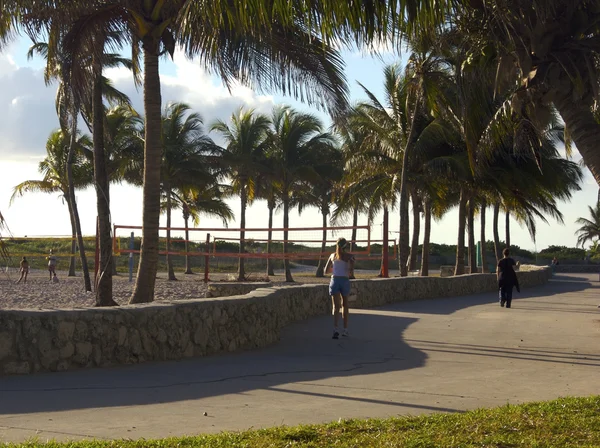 Woman working out in the morning in Miami Beach in front of Ocean Drive Street.