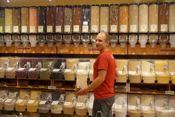 Bulk bins with worker at health food store