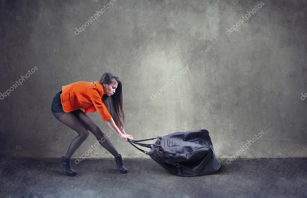 Woman carrying heavy bag — Stock Photo © undrey 23752599