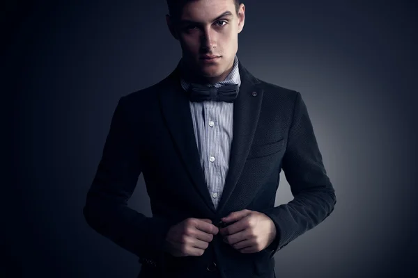 Portrait of  attractive handsome stylish fashion young man in elegant casual classical suit with bow tie  vogue style