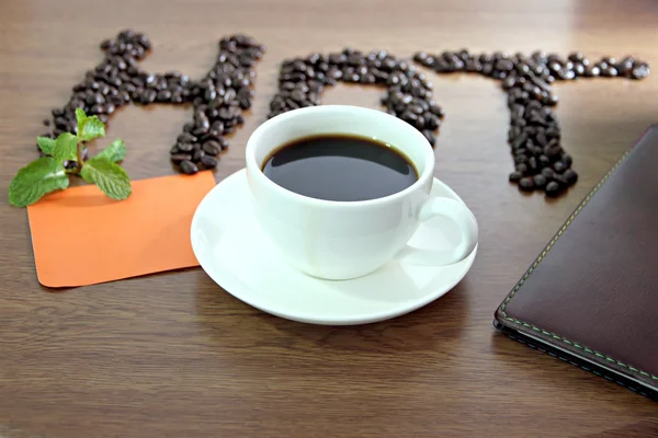 White coffee cup and paper note orange lettering that hot.