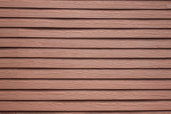 Walls of the house are made of oak wood color.