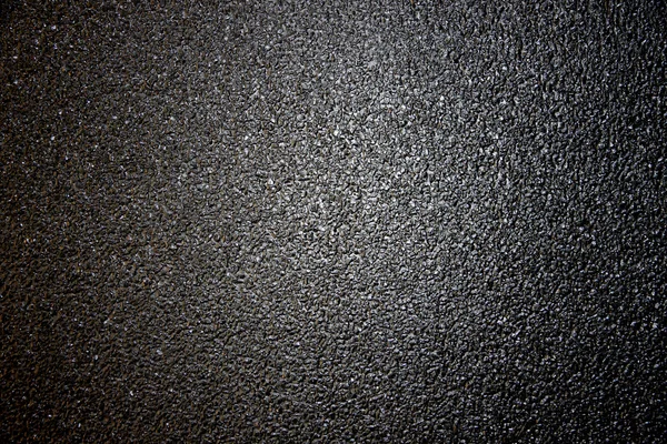 Dark color of asphalt road surface.