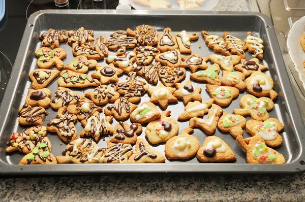 Baking tray full of homemade, decorated cookies for Christmas