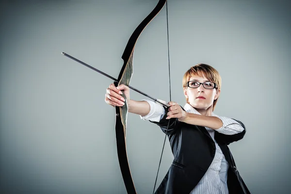 Business woman aiming with bow and arrow