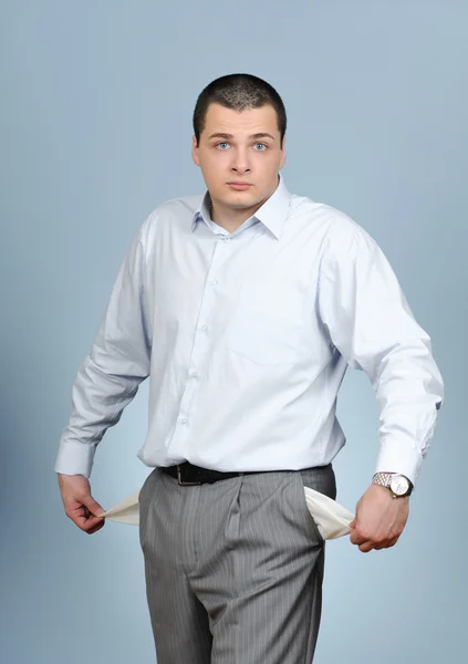 Businessman pulling out empty pockets