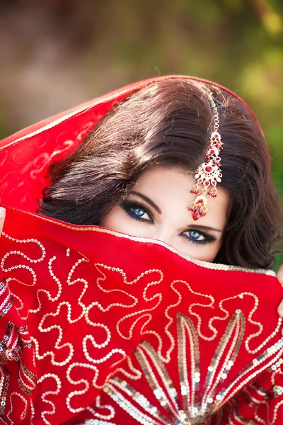 Beautiful Indian woman portrait, bright makeup woman with golden jewelry