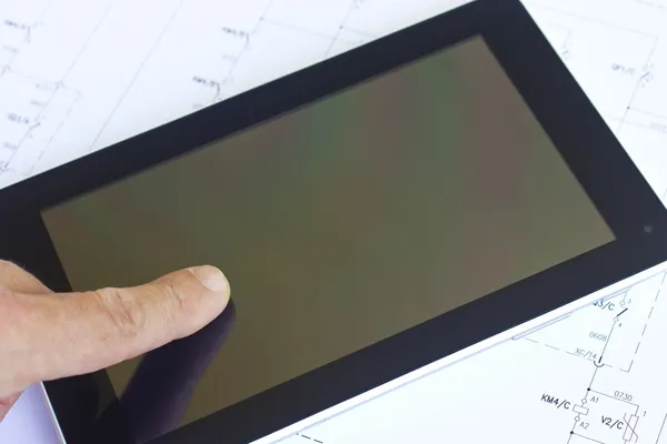 Man working with tablet over engineering diagram