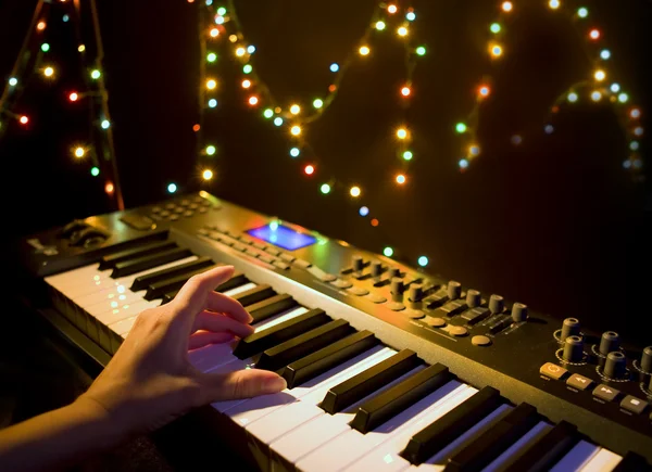 Musician playing on musical keyboard
