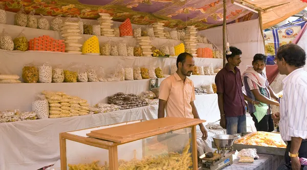 GOKARNA,INDIA - MAR 11: Unidentified man sells a sweet food in G