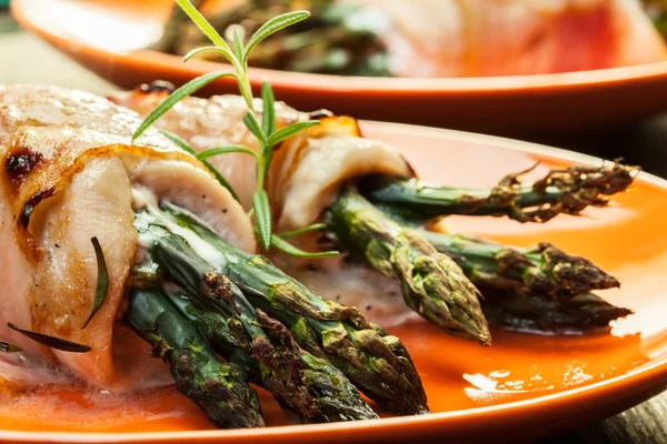 Baked asparagus wrapped in chicken and bacon