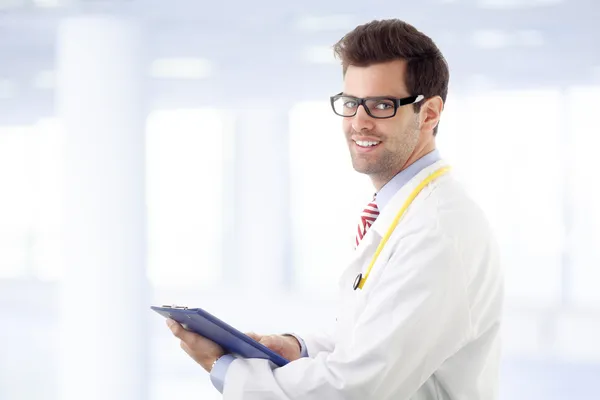 Male doctor examining medical report