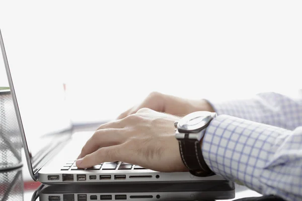 Businessman working on laptop. Isolated on white background.