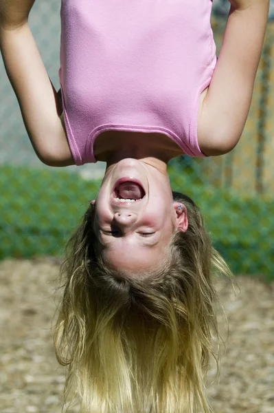 Blond girl hanging upside down