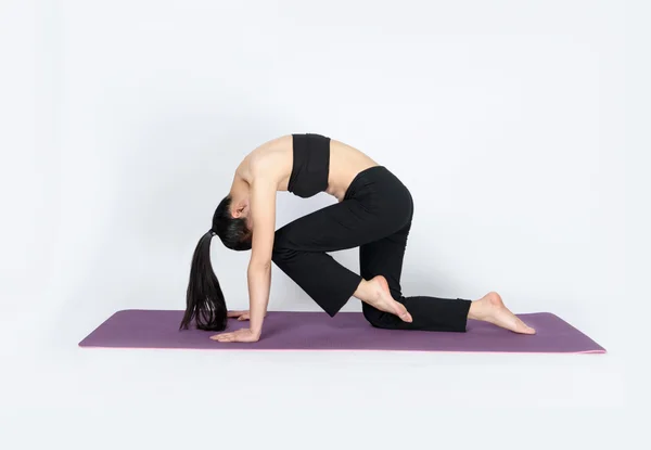 Young woman training yoga on white background