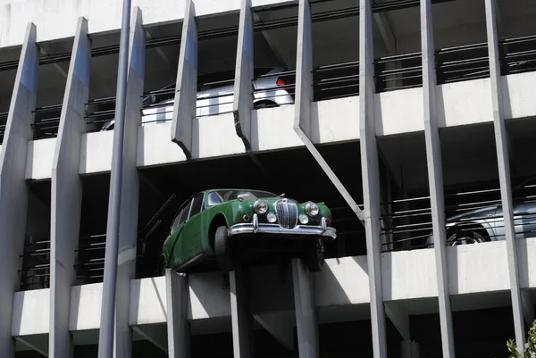 A Green Jaguar car crashed through a multi-story car park.