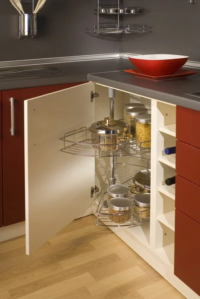 Detail of a circular open kitchen cabinet with cans of beans