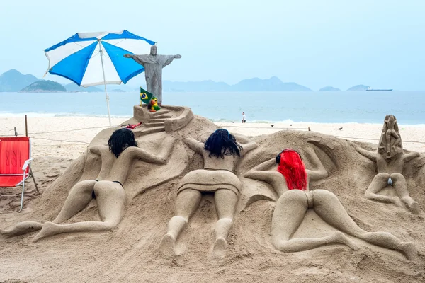Sand sculpture sunbathe on the beach of Copacabana