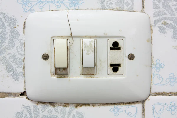 Dirty old wall socket and switches
