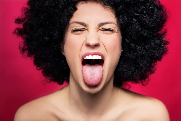 Woman with afro sticking her tongue out
