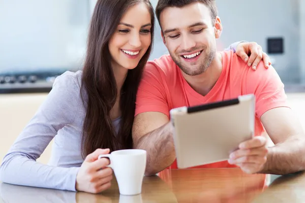 Smiling couple with digital tablet