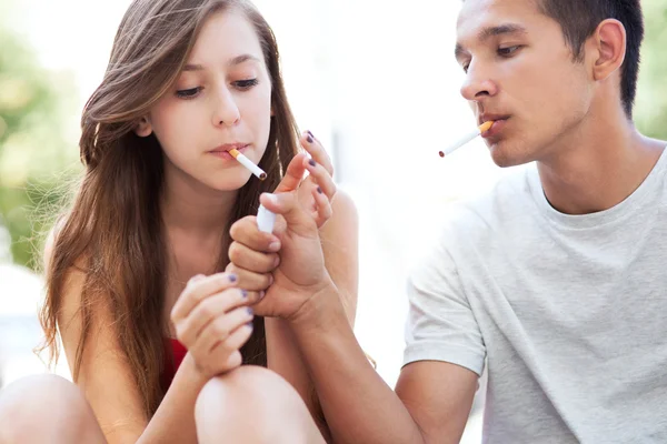 Teenage couple smoking