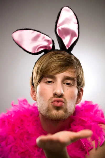 Man in bunny ears blowing kiss