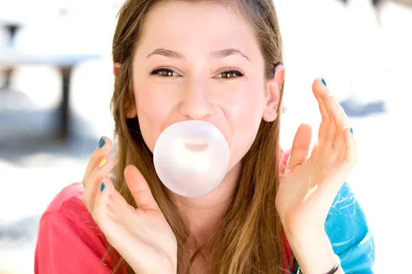 Young girl blowing bubble gum