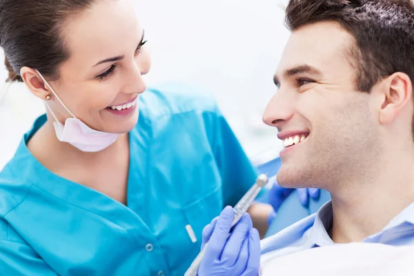 Female dentist with male patient