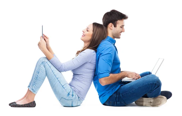 Couple with laptop and digital tablet